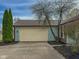 Exterior image of a two car attached garage with blue siding and a beige trim at 9362 Helmsdale Dr, Indianapolis, IN 46256