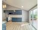 Modern kitchen with wood flooring, stainless appliances, and access to the deck at 9362 Helmsdale Dr, Indianapolis, IN 46256