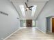 Bright living room with vaulted ceilings, skylights, brick fireplace and light wood-look flooring at 9362 Helmsdale Dr, Indianapolis, IN 46256