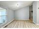 Living room featuring vaulted ceiling, light gray walls, and luxury vinyl flooring and a large window at 9362 Helmsdale Dr, Indianapolis, IN 46256