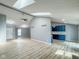 Large living room with vaulted ceilings, skylights, and luxury vinyl flooring with a neutral color palette at 9362 Helmsdale Dr, Indianapolis, IN 46256