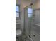 This bathroom features a clean glass shower and a window at 9882 Woodbriar Ln, Carmel, IN 46280