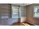 Bedroom with built-in shelves and storage, complemented by hardwood floors and natural light at 9882 Woodbriar Ln, Carmel, IN 46280