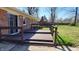 Wooden deck featuring dark-stained wood and overlooking a well-maintained lawn and surrounding landscape at 9882 Woodbriar Ln, Carmel, IN 46280