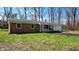 Well-maintained brick home with a green lawn, a charming porch swing, and a two-car garage at 9882 Woodbriar Ln, Carmel, IN 46280
