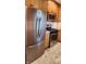 Modern kitchen with stainless steel appliances, including a refrigerator, microwave, and range at 9882 Woodbriar Ln, Carmel, IN 46280
