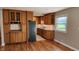 Spacious kitchen with oak cabinets, granite countertops, stainless steel appliances, and hardwood floors nearby at 9882 Woodbriar Ln, Carmel, IN 46280