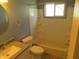 Cozy bathroom featuring a tub, shower, toilet, sink and vanity, with a window providing natural light at 99 Armitage St, Cicero, IN 46034