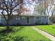 Charming single-story home with a blue exterior, green lawn, and mature trees at 99 Armitage St, Cicero, IN 46034