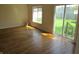Bright living room featuring hardwood floors, a large window, and a sliding glass door to the yard at 99 Armitage St, Cicero, IN 46034
