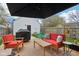 Outdoor deck with comfortable red outdoor furniture and grill at 1015 Villa Ave, Indianapolis, IN 46203