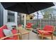 Back deck with modern red furniture and dark umbrella at 1015 Villa Ave, Indianapolis, IN 46203