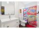Bright bathroom featuring a white vanity, framed mirror, and fun, comic-themed shower curtain at 1015 Villa Ave, Indianapolis, IN 46203