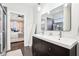Bright bathroom featuring dual sinks, a mirror, and an ensuite bedroom at 1015 Villa Ave, Indianapolis, IN 46203