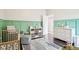 bedroom showcasing an accent wall, wooden crib, and organized storage in a playful, well-appointed space at 1015 Villa Ave, Indianapolis, IN 46203