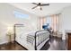 Comfortable bedroom featuring dark floors, a ceiling fan and lots of natural light from the windows at 1015 Villa Ave, Indianapolis, IN 46203