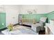 Brightly decorated bedroom features a wooden crib, accent wall, and playful decor for a cheerful space at 1015 Villa Ave, Indianapolis, IN 46203