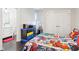 Playful bedroom with colorful bedding, adjacent dresser, and ample storage for an organized and vibrant space at 1015 Villa Ave, Indianapolis, IN 46203