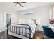 Comfortable bedroom featuring dark floors, a ceiling fan and lots of natural light from the windows at 1015 Villa Ave, Indianapolis, IN 46203
