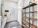 Bright entryway featuring dark hardwood floors, a modern shelving unit, and natural light at 1015 Villa Ave, Indianapolis, IN 46203