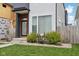 Stylish front entrance with modern door, wood accents, black trim, and landscaped yard at 1015 Villa Ave, Indianapolis, IN 46203