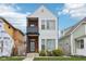 Modern two-story home featuring vinyl siding, balcony and charming front yard landscaping at 1015 Villa Ave, Indianapolis, IN 46203