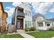 Modern two-story home featuring vinyl siding, balcony, landscaped front yard and walkway at 1015 Villa Ave, Indianapolis, IN 46203