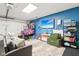 Finished garage as a playroom with television, toys, and comfortable gray sofa at 1015 Villa Ave, Indianapolis, IN 46203