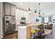 Open kitchen with island seating, stainless steel appliances, and seamless flow to the living area at 1015 Villa Ave, Indianapolis, IN 46203