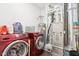Functional laundry room features red washer/dryer set and modern utilities for efficient home maintenance at 1015 Villa Ave, Indianapolis, IN 46203