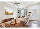 Cozy living room showcasing stylish sectional sofa, ceiling fan, and large-screen television at 1015 Villa Ave, Indianapolis, IN 46203
