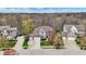 Aerial view of a well-maintained home with a manicured lawn, mature trees, and a three-car garage at 10814 Tallow Wood Ln, Indianapolis, IN 46236