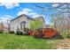 Backyard featuring a spacious deck with a view of the landscaped yard and mature trees at 10814 Tallow Wood Ln, Indianapolis, IN 46236