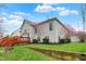 Well-maintained backyard featuring a spacious lawn, beautiful landscaping, and a deck, perfect for outdoor entertaining at 10814 Tallow Wood Ln, Indianapolis, IN 46236