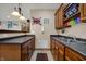 Bar area with wood cabinets, wine rack, sink, and granite countertops at 10814 Tallow Wood Ln, Indianapolis, IN 46236