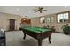 Finished basement with a billiards table, wet bar, and natural light from windows at 10814 Tallow Wood Ln, Indianapolis, IN 46236