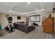 Spacious finished basement showcasing a large screen, workout equipment, and entertainment area at 10814 Tallow Wood Ln, Indianapolis, IN 46236
