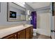 Neutral toned bathroom with dark wood cabinets, a shower with galaxy curtain, and tile floor at 10814 Tallow Wood Ln, Indianapolis, IN 46236