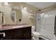 Bathroom featuring a vanity with sink, a toilet, and a glass-enclosed shower at 10814 Tallow Wood Ln, Indianapolis, IN 46236