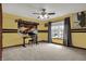 Bright bedroom featuring a fan, desk area, and light yellow paint scheme at 10814 Tallow Wood Ln, Indianapolis, IN 46236