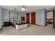 Bright bedroom with a four poster bed, walk in closet, and overhead chandelier at 10814 Tallow Wood Ln, Indianapolis, IN 46236