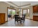 Cozy breakfast nook with a bay window, sliding glass door, and views of the backyard at 10814 Tallow Wood Ln, Indianapolis, IN 46236
