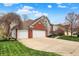 Charming two-story home with a brick facade, three-car garage, and well-manicured lawn at 10814 Tallow Wood Ln, Indianapolis, IN 46236