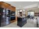 Bright kitchen with stainless steel appliances, black island, and an open layout to the breakfast nook at 10814 Tallow Wood Ln, Indianapolis, IN 46236