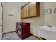 Well-equipped laundry room with washer, dryer, utility sink, and ample storage at 10814 Tallow Wood Ln, Indianapolis, IN 46236