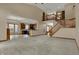 Open-concept living space with a staircase and view of the kitchen at 10814 Tallow Wood Ln, Indianapolis, IN 46236