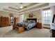 Spacious main bedroom featuring a tray ceiling, and large windows at 10814 Tallow Wood Ln, Indianapolis, IN 46236