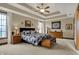 Serene main bedroom featuring a tray ceiling, neutral tones, and plenty of natural light at 10814 Tallow Wood Ln, Indianapolis, IN 46236