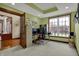 Bright home office with a large window, neutral carpet, and glass panel French doors at 10814 Tallow Wood Ln, Indianapolis, IN 46236