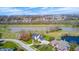 Scenic aerial view of a residential area with a home nestled beside a pond and a lush green golf course at 10846 Hamilton Pass, Fishers, IN 46037